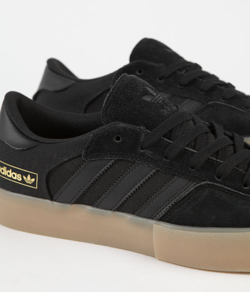 Black adidas with gold sole shop