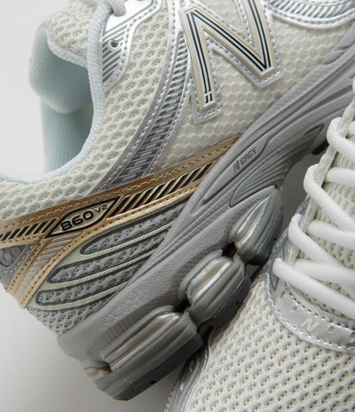 New Balance 860 Shoes in Sea Salt and Gold Metallic