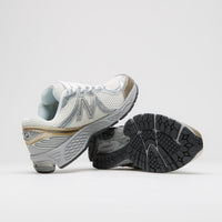 New Balance 860 Shoes in Sea Salt and Gold Metallic thumbnail