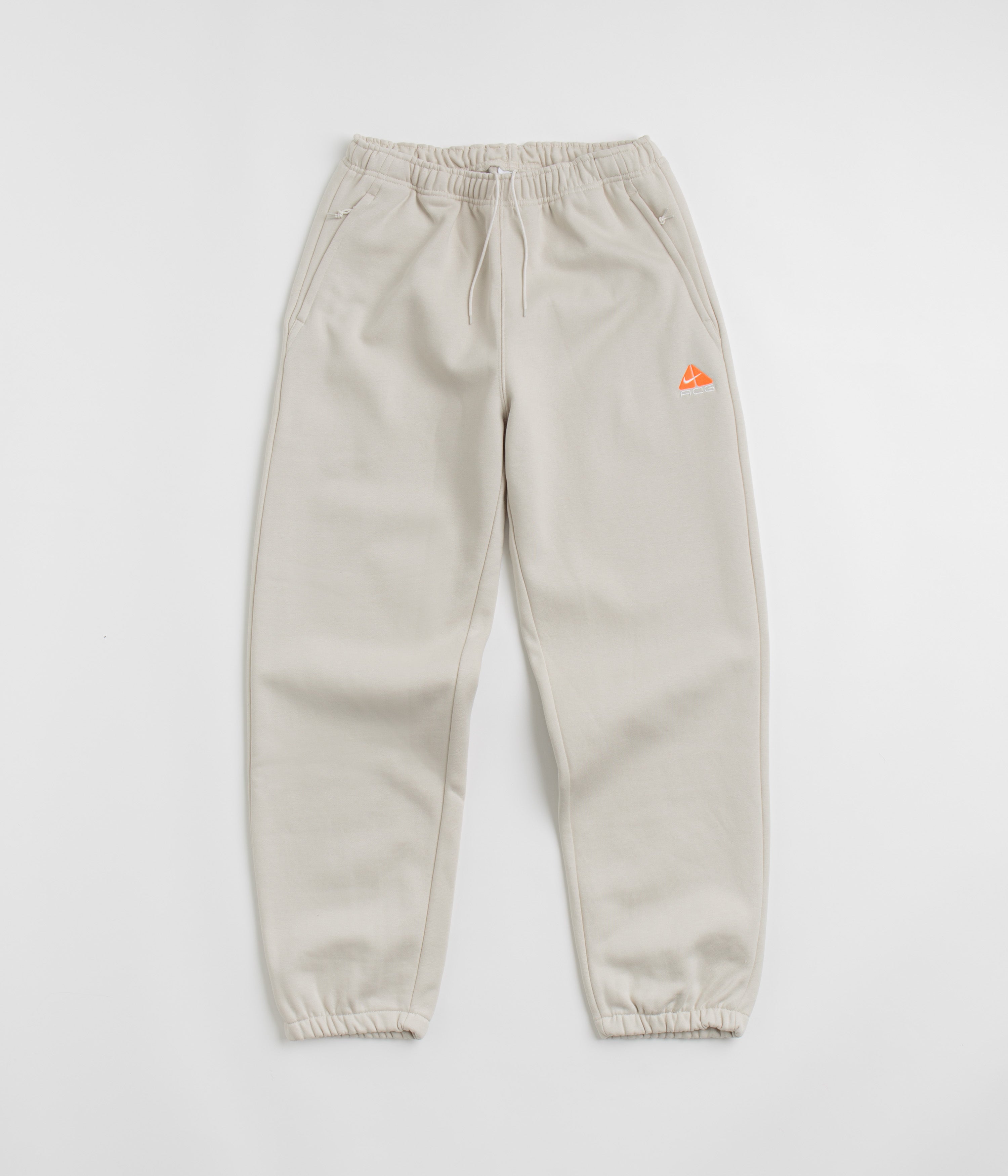 Nike ACG Tuff Fleece Lungs Pants in Light Orewood Brown and Hyper Crimson