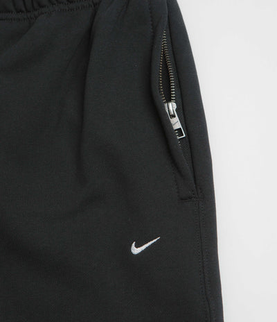 Nike Solo Swoosh Cuffed Sweatpants in Black and Black / White