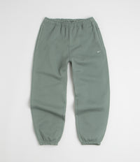 Nike Solo Swoosh Cuffed Sweatpants in Clay Green and Clay Green / White